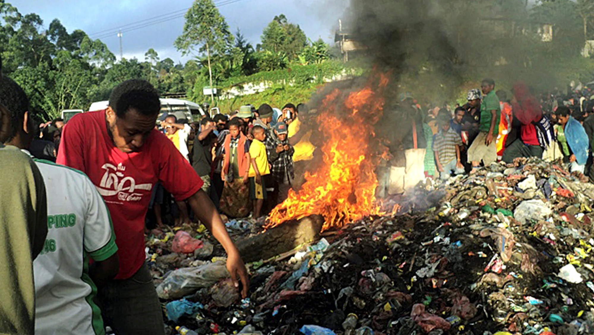 The accused witch Helen Rumbali being burned to death as villagers watch